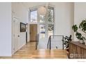 Bright foyer with hardwood floors, modern staircase, and expansive windows, creating a welcoming entrance at 1580 Moss Rock Pl, Boulder, CO 80304