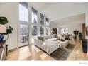 Sunlit living room features vaulted ceilings, a modern sofa, and large windows with inviting outdoor views at 1580 Moss Rock Pl, Boulder, CO 80304