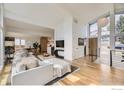Spacious living room with an open floor plan, hardwood floors, and large windows offering natural light at 1580 Moss Rock Pl, Boulder, CO 80304