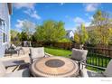 Spacious backyard with patio, seating, and lush green lawn, perfect for outdoor entertaining at 16478 Marion St, Thornton, CO 80602