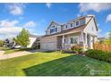 Beautiful two-story home with a well-manicured lawn and attached two-car garage at 16478 Marion St, Thornton, CO 80602