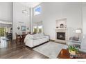 Bright living room featuring hardwood floors, fireplace, and adjacent dining area with modern decor at 16478 Marion St, Thornton, CO 80602