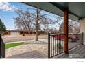 Inviting front porch with stone pavers, railings, and view of a manicured lawn, enhancing the home's curb appeal at 1700 Jewel Dr, Longmont, CO 80501