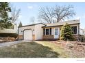 Inviting ranch-style home with a single-car garage and neatly landscaped front yard at 17124 E Wagon Trail Pkwy, Aurora, CO 80015