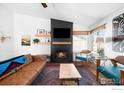 Stylish living room with modern fireplace, floating shelves, and comfortable seating at 17124 E Wagon Trail Pkwy, Aurora, CO 80015