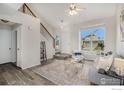 Bright living room with hardwood floors and an open staircase at 180 N Holcomb St, Castle Rock, CO 80104