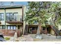Exterior of a multi-level condo with a large pine tree and balconies at 1825 Marine St # 8, Boulder, CO 80302