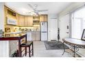 Bright kitchen with modern appliances, a breakfast bar, and ample cabinet space at 1825 Marine St # 8, Boulder, CO 80302