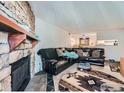 Cozy living room featuring a stone fireplace and a comfortable leather sectional at 1864 S Pitkin Cir # B, Aurora, CO 80017