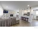 Inviting living room with a modern fireplace, gray couch, and an open layout to the kitchen at 2136 S Balsam Ct, Lakewood, CO 80227