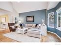 Inviting living room with vaulted ceilings, plush carpet and eye-catching accent wall at 2215 Barn Swallow Dr, Longmont, CO 80504