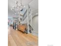 Open staircase with contemporary metal railings and hardwood floors at 2890 Curtis St, Denver, CO 80205