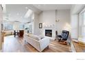 Bright living room with a vaulted ceiling, skylight, fireplace, and open concept kitchen at 3206 Columbine Ct, Broomfield, CO 80020