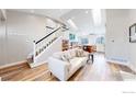 Open-concept living space featuring stairs, modern flooring, and an airy atmosphere at 3206 Columbine Ct, Broomfield, CO 80020