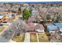 An aerial view of a suburban home with a driveway and landscaped yard, surrounded by trees and other houses at 3690 Conifer Ct, Boulder, CO 80304