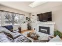 Comfortable living room with fireplace, a modern television, and lots of natural light from a skylight at 419 22Nd St, Boulder, CO 80302