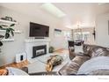 Inviting living room with fireplace, a modern television, and natural light from a skylight at 419 22Nd St, Boulder, CO 80302