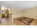 Spacious living room showing an open layout with hardwood floors connecting to the tiled entry at 4480 Hastings Dr, Boulder, CO 80305