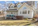 Inviting home showcasing a lovely front porch with seating and large windows, perfect for enjoying the outdoors at 7430 Cardinal Ln, Longmont, CO 80503