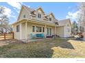 Attractive home offering a cozy front porch with ample seating and a well-maintained yard at 7430 Cardinal Ln, Longmont, CO 80503