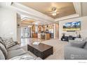 Spacious living room flowing into the open kitchen, with modern decor and ample seating at 7891 St Vrain Dr, Frederick, CO 80530