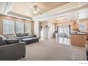 Inviting living room featuring carpet floors, recessed ceiling and natural light at 7891 St Vrain Dr, Frederick, CO 80530