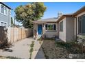 Charming home exterior featuring a fenced yard and convenient side driveway at 828 Mariposa St, Denver, CO 80204