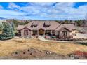 Expansive single-Gathering home with a tile roof, mature trees, and a spacious front yard at 8604 Portico Ln, Longmont, CO 80503