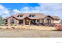 Inviting single-Gathering home boasting stone detailing, a tile roof, and a well-manicured front lawn at 8604 Portico Ln, Longmont, CO 80503