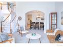 Inviting living space flows into dining area, showcasing an open-concept design and natural light at 1069 Monarch Way, Superior, CO 80027