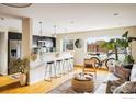 Open-concept living area with bar seating, a modern kitchen, and natural light at 1201 Balsam Ave # 302, Boulder, CO 80304
