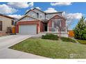 Charming two-story home with a combination brick and gray siding, and well-maintained lawn at 12917 Fox St, Westminster, CO 80234