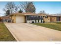 A welcoming driveway leads to this cozy home, featuring a spacious front yard at 169 Emerald St, Broomfield, CO 80020