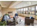 Bright sunroom featuring large windows, comfortable seating, and stylish decor, perfect for relaxation at 169 Emerald St, Broomfield, CO 80020
