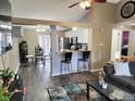 Comfortable living room showcasing wood floors, a breakfast bar, and an open floor plan at 1754 Linden St, Longmont, CO 80501