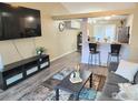Open-concept living room with wood floors, modern furniture, and a mounted TV at 1754 Linden St, Longmont, CO 80501