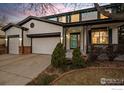 Charming two-story home featuring a two-car garage, a front porch, and a well-maintained lawn at 1808 Southard St, Erie, CO 80516