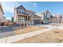 Street view of a lovely home with a covered porch and neat front yard in a residential neighborhood at 1881 Miranda Rd, Erie, CO 80516