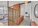 Open hallway featuring wooden railing and view of dining area with great natural light at 2425 Vassar Dr, Boulder, CO 80305