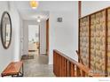 Well-lit hallway featuring tile flooring and classic mid-century modern details at 2425 Vassar Dr, Boulder, CO 80305