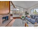 Comfortable living room with exposed brick, hardwood floors, and mountain views at 2425 Vassar Dr, Boulder, CO 80305