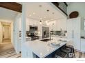 Modern kitchen features a large island with seating, pendant lighting, and stainless steel appliances at 2650 Hawthorne Pl, Boulder, CO 80304