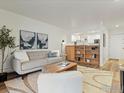 Comfortable living room featuring stylish decor, plush seating, and a view into the kitchen at 2707 Valmont Rd # 307, Boulder, CO 80304