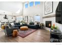 Open-concept living area showcasing a cozy fireplace, modern decor, and seamless flow to the kitchen at 299 Bronco Ct, Berthoud, CO 80513