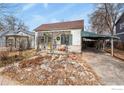 Cozy single-story home with a well-maintained front yard and a detached carport, full of character at 305 E Cannon St, Lafayette, CO 80026