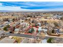 Wide aerial shot showcasing the home's placement in the neighborhood with mountain views in the distance at 329 2Nd St, Frederick, CO 80530