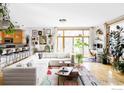 Bright living room with large windows, light hardwood floors, and stylish decor at 3299 Lowell Blvd # 103, Denver, CO 80211