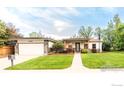 Charming single-story home featuring a well-manicured lawn, stone accents, and a welcoming front entrance at 3380 Longwood Ave, Boulder, CO 80305