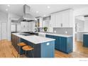 Spacious kitchen features a large island with seating, stainless steel appliances, and custom cabinetry at 3380 Longwood Ave, Boulder, CO 80305