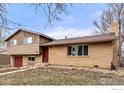 Two-story home with brick and wood siding, a well-manicured lawn, and a red front door at 3605 Moorhead Ave, Boulder, CO 80305